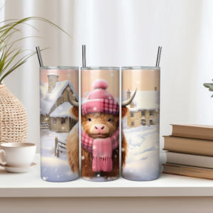 baby highland cow wearing pink hat and scarf in snowy setting